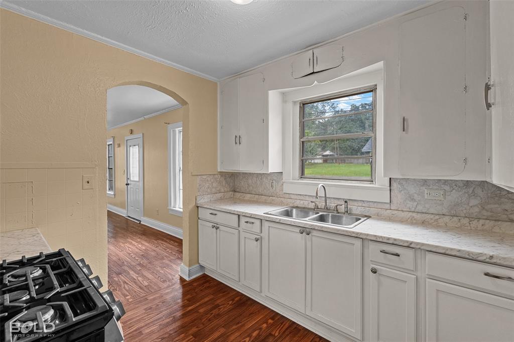 115 Pam Street Mansfield, LA 71052 - Photo 11 of 25 a kitchen with a sink stove and cabinets