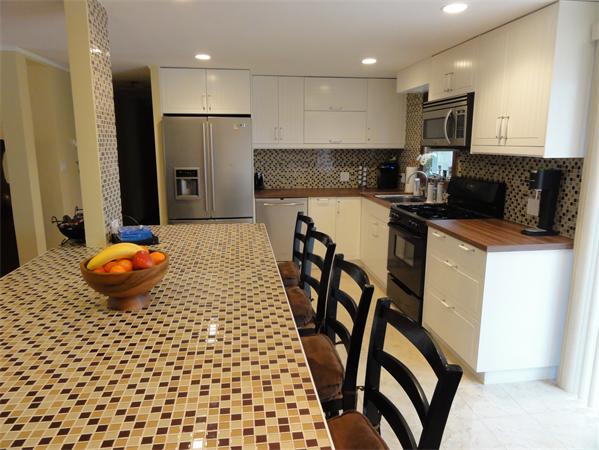 12 Weathervane Road Billerica, MA 01821 - Photo 4 of 30 a kitchen with stainless steel appliances a refrigerator and a stove top oven