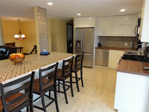 12 Weathervane Road Billerica, MA 01821 - Photo 5 of 30 a kitchen with a refrigerator and wooden floor