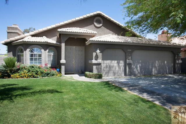 68130 Perlita Road Cathedral City, CA 92234 - Photo 1 of 19 a front view of a house with a yard and garage