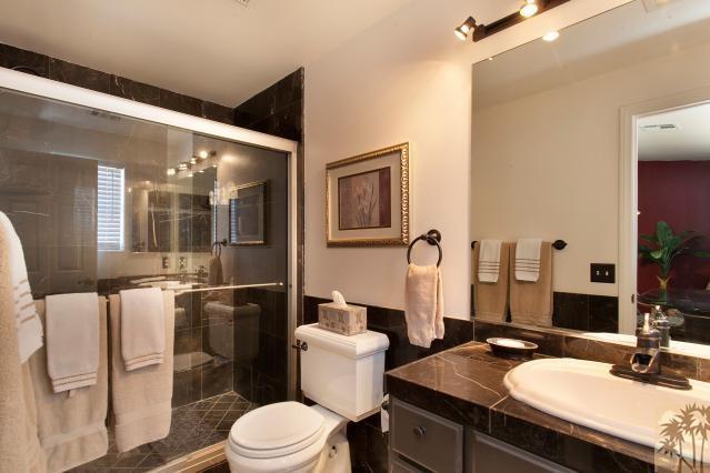 68130 Perlita Road Cathedral City, CA 92234 - Photo 13 of 19 a bathroom with a granite countertop toilet sink and mirror