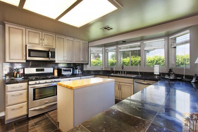 68130 Perlita Road Cathedral City, CA 92234 - Photo 5 of 19 a kitchen with a stove a sink and a microwave