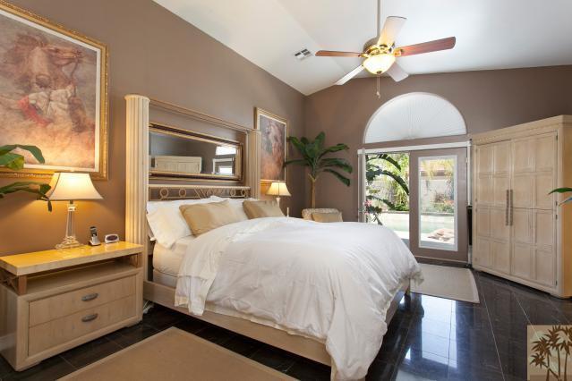 68130 Perlita Road Cathedral City, CA 92234 - Photo 10 of 19 a bedroom with a bed chandelier and a window