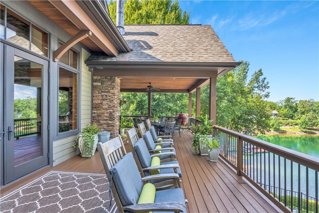 256 Talton Road Six Mile, SC 29682 - Photo 42 of 50 An elevated wood deck wraps the exterior, overlooking tranquil waters and lush greenery.