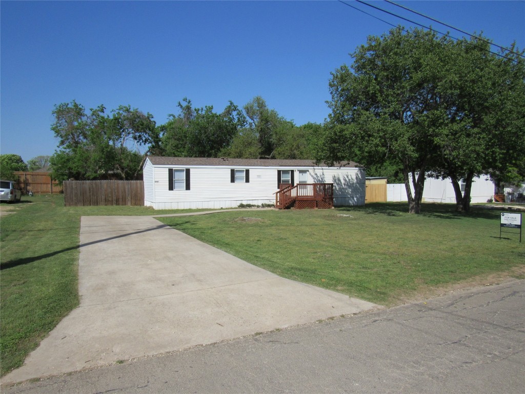 a house view with a play ground in front of it
