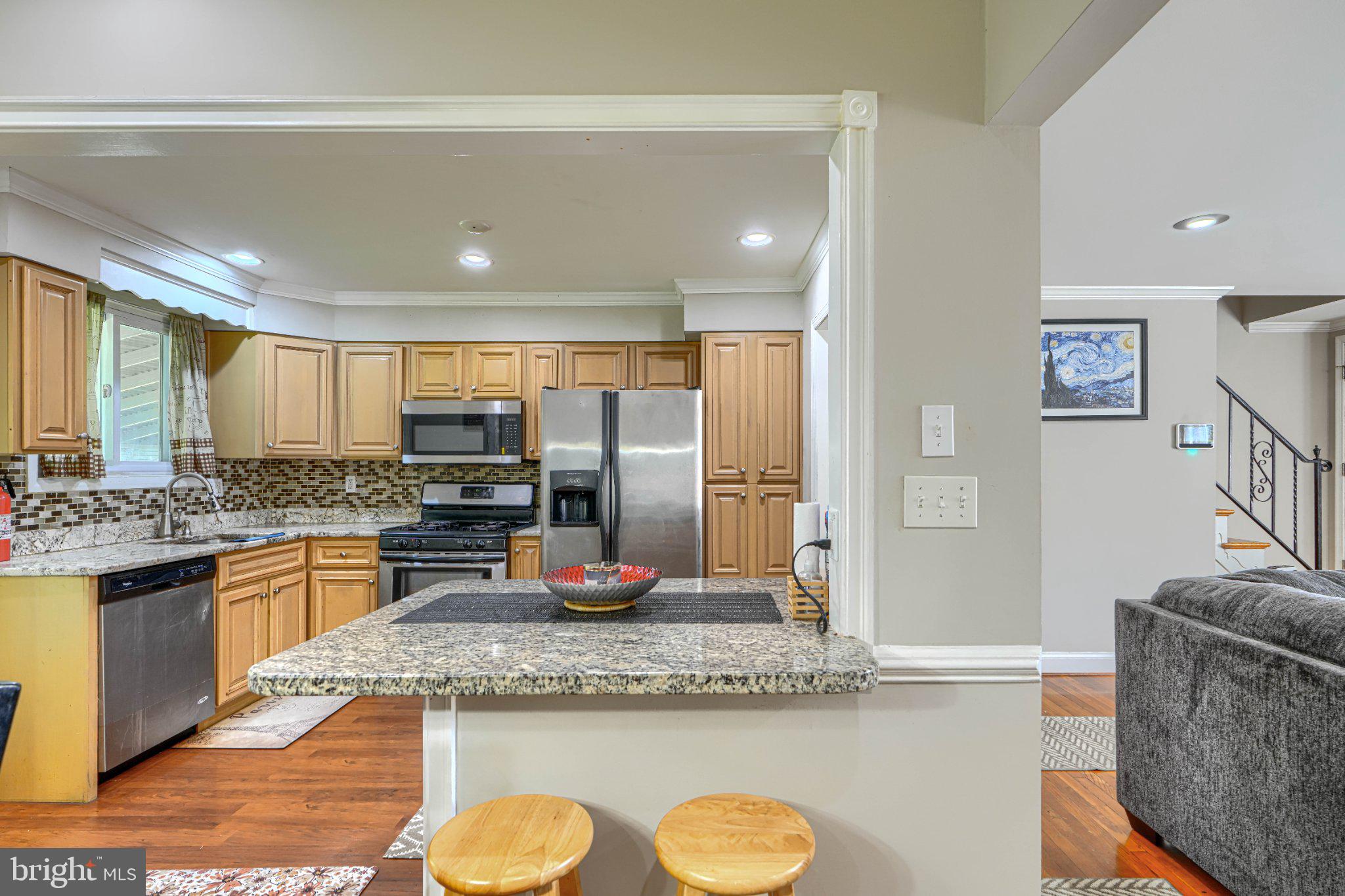 3708 Cassen Road Randallstown, MD 21133 - Photo 11 of 38 a kitchen with stainless steel appliances granite countertop a sink stove and refrigerator