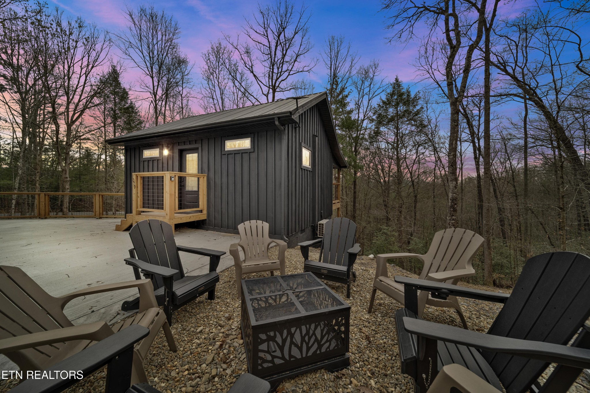 a view of backyard with outdoor seating and trees