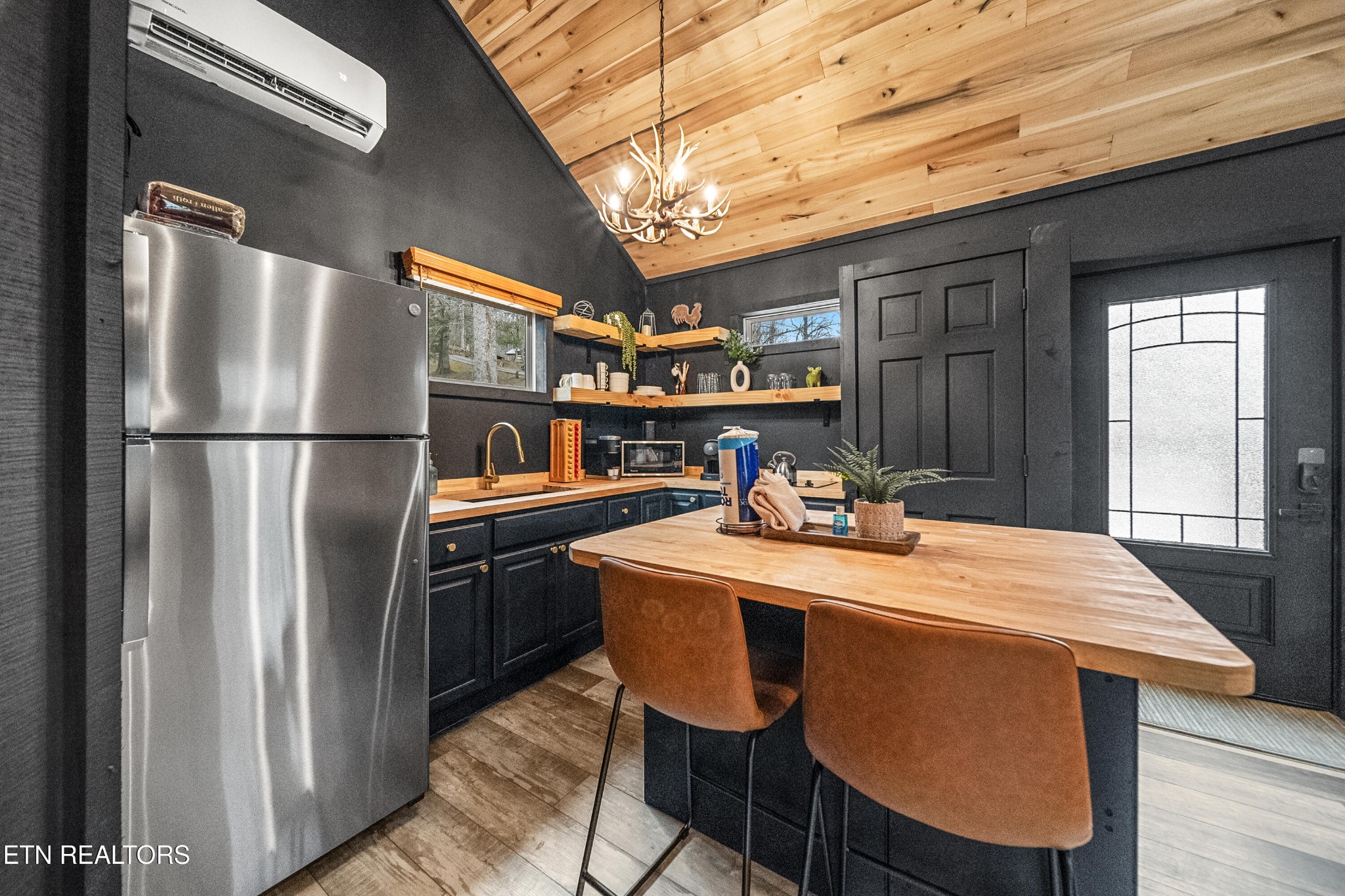 1079 Shell Mountain Road Sevierville, TN 37876 - Photo 12 of 29 a kitchen with stainless steel appliances granite countertop a dining table chairs refrigerator and stove