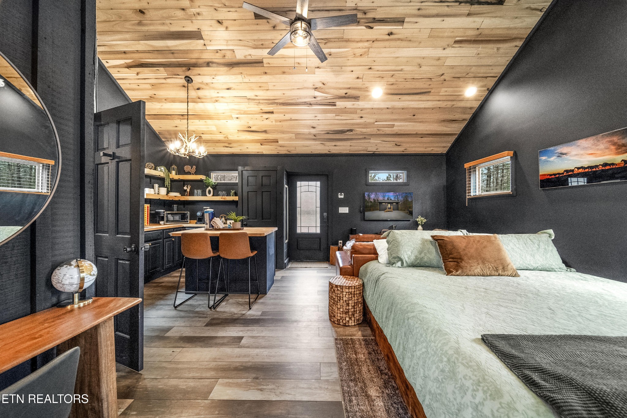 1079 Shell Mountain Road Sevierville, TN 37876 - Photo 2 of 29 a large bedroom with a bed and wooden floor