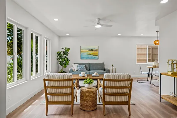 a dining room with furniture and wooden floor
