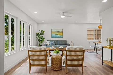 a dining room with furniture and wooden floor