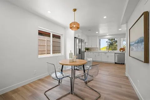 a view of a kitchen with a table and chairs