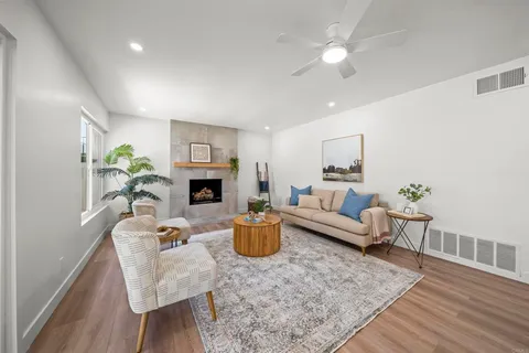 a living room with furniture and a fireplace