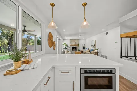 a kitchen with a stove and a chandelier