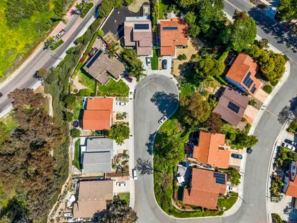 an aerial view of residential houses with outdoor space