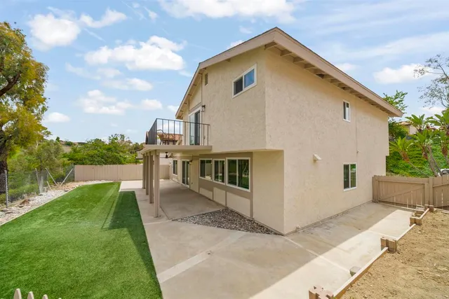 a view of house with backyard