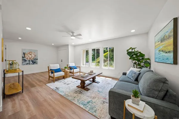 a living room with furniture and a large window