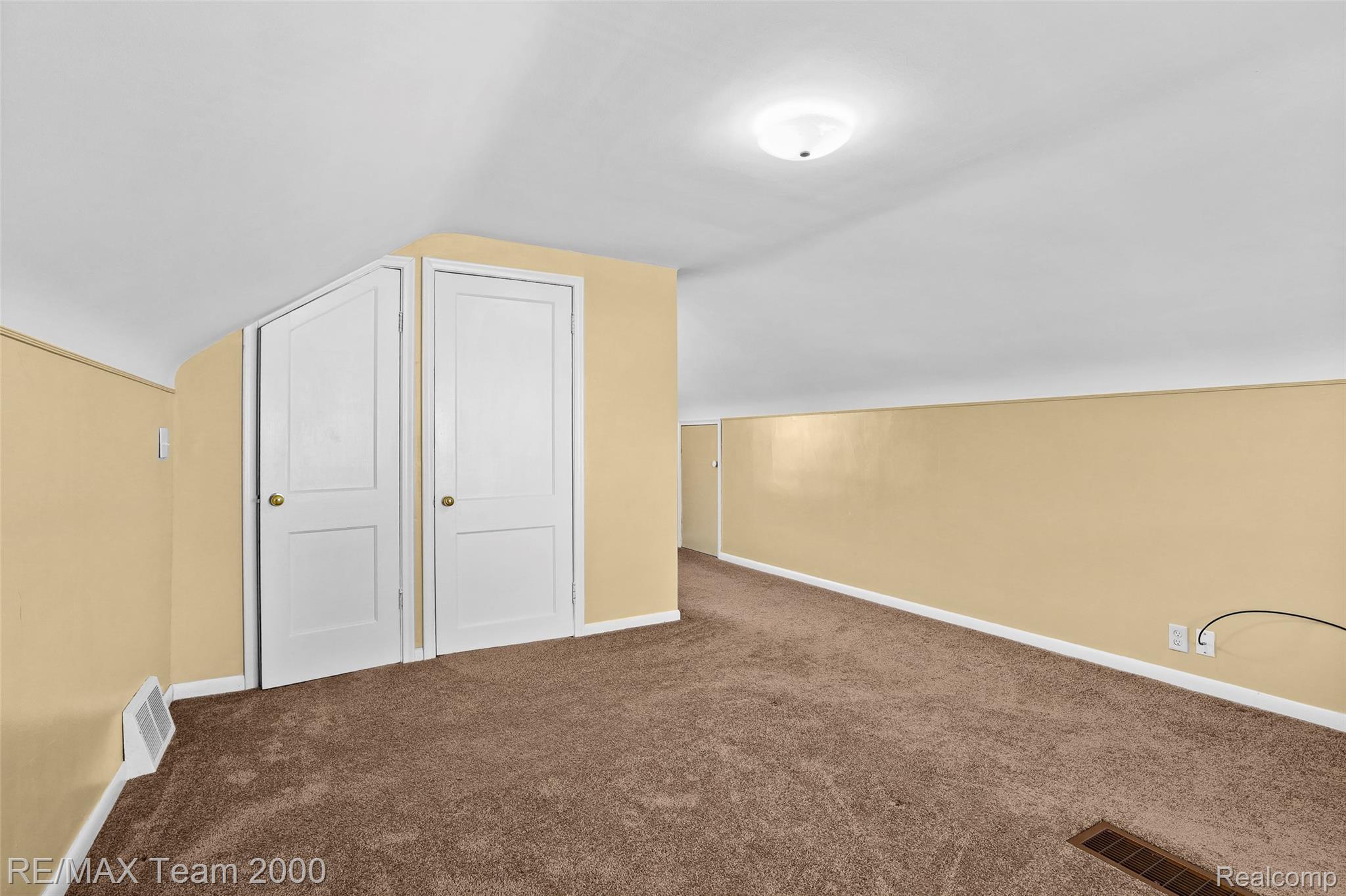 3130 Chestnut Street Dearborn, MI 48124 - Photo 20 of 30 Carpeted room featuring sloped ceilings and a pair of white paneled doors