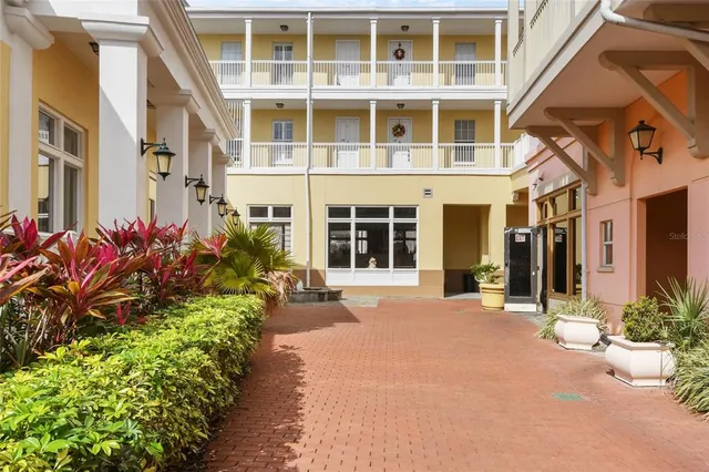 a front view of a building with a garden