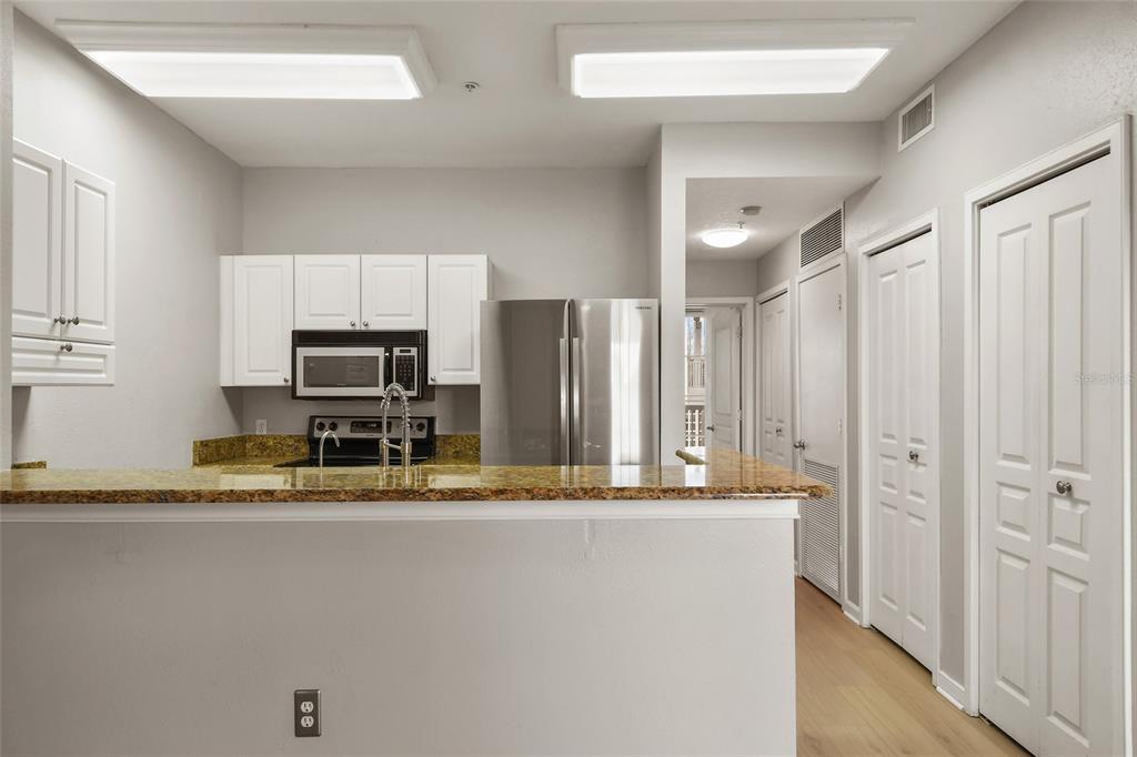 600 Market Street, Unit 340 Celebration, FL 34747 - Photo 11 of 35 a kitchen with stainless steel appliances granite countertop a refrigerator and a sink