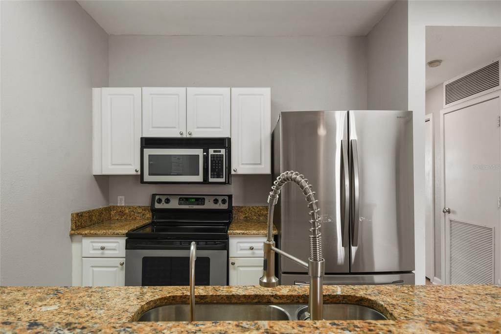 600 Market Street, Unit 340 Celebration, FL 34747 - Photo 13 of 35 a kitchen with a refrigerator stove and microwave