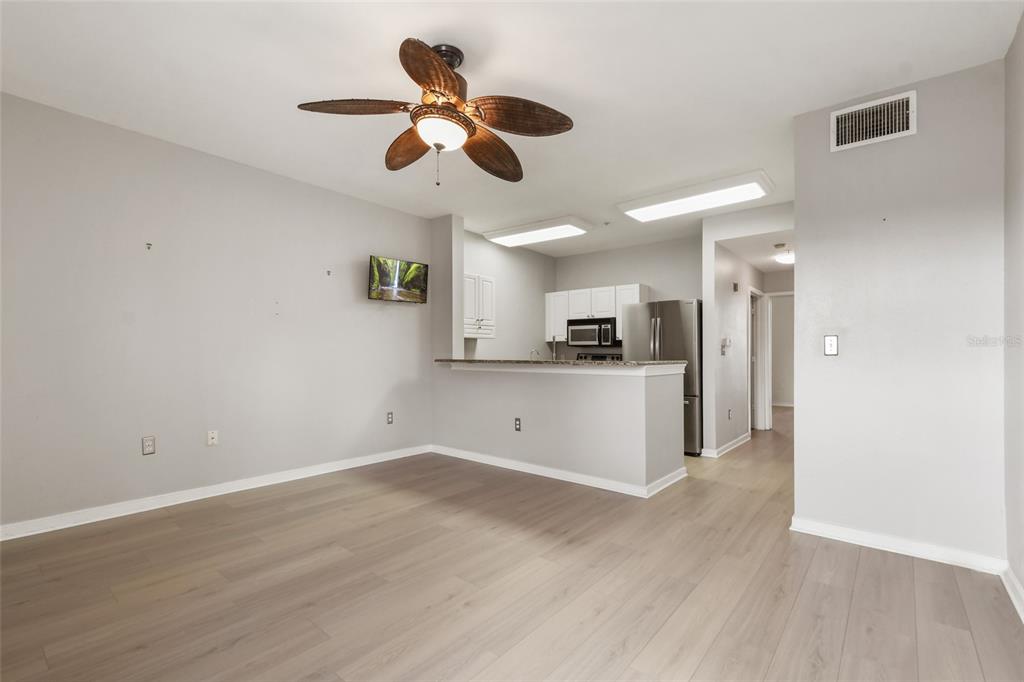 600 Market Street, Unit 340 Celebration, FL 34747 - Photo 14 of 35 a view of kitchen with refrigerator microwave and wooden floor