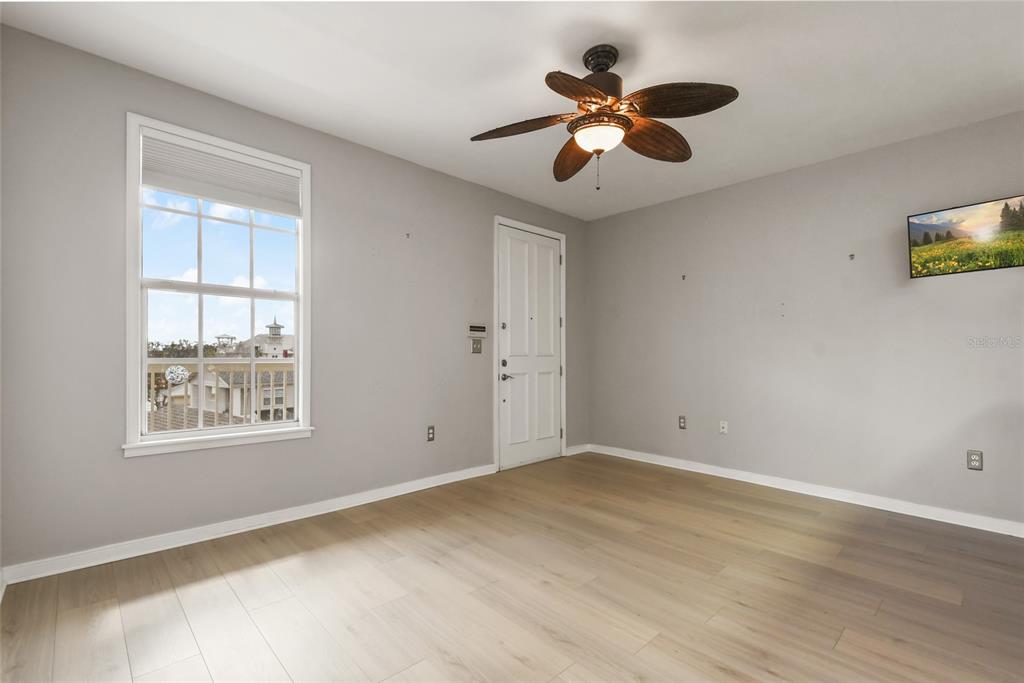 600 Market Street, Unit 340 Celebration, FL 34747 - Photo 16 of 35 a view of an empty room with a window and a ceiling fan