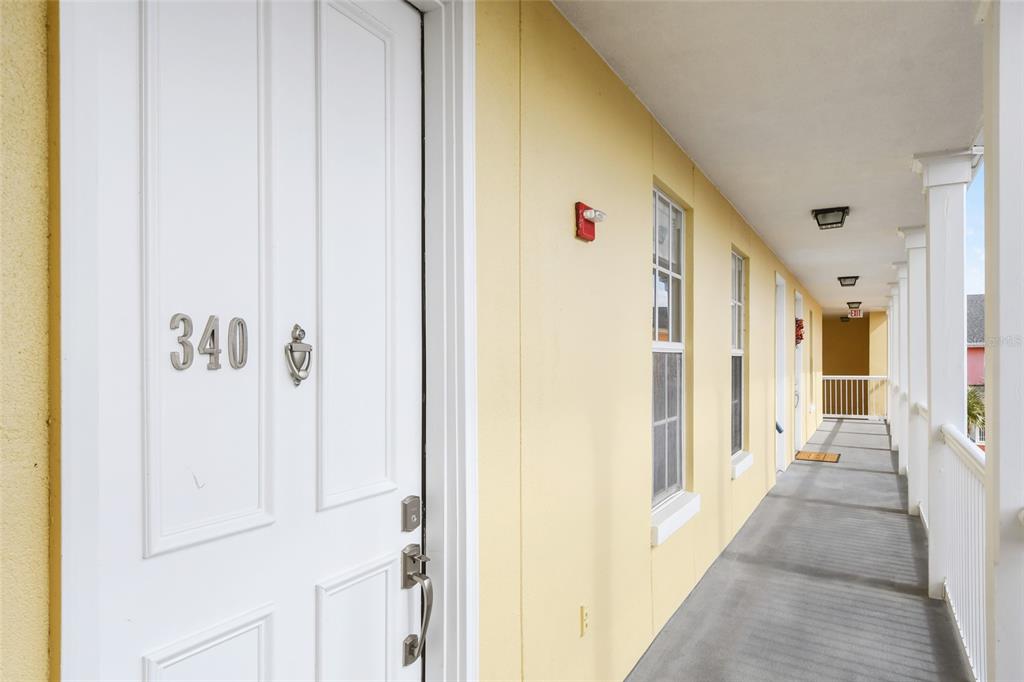 600 Market Street, Unit 340 Celebration, FL 34747 - Photo 2 of 35 a view of a hallway with wooden shelves