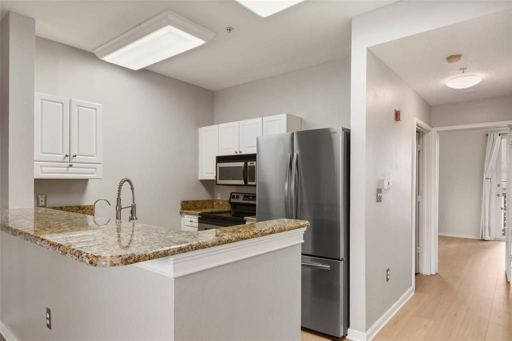 600 Market Street, Unit 340 Celebration, FL 34747 - Photo 3 of 35 a kitchen with stainless steel appliances granite countertop a refrigerator and a sink