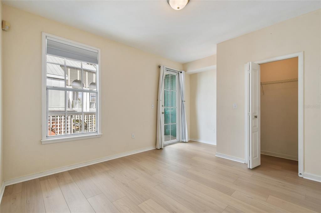 600 Market Street, Unit 340 Celebration, FL 34747 - Photo 5 of 35 an empty room with wooden floor and windows