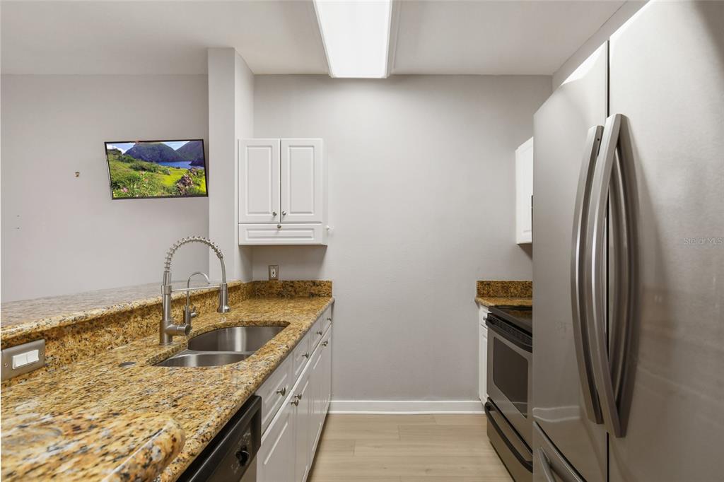 600 Market Street, Unit 340 Celebration, FL 34747 - Photo 9 of 35 a kitchen with stainless steel appliances granite countertop a refrigerator and a sink