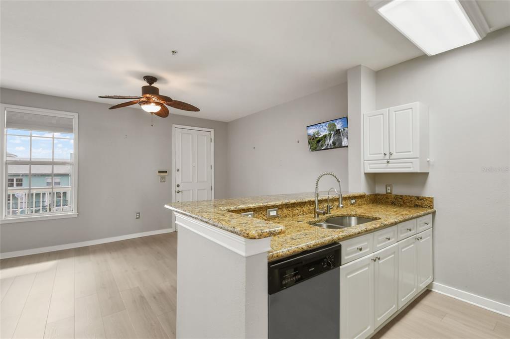 600 Market Street, Unit 340 Celebration, FL 34747 - Photo 10 of 35 a view of kitchen island a sink a stove and cabinets
