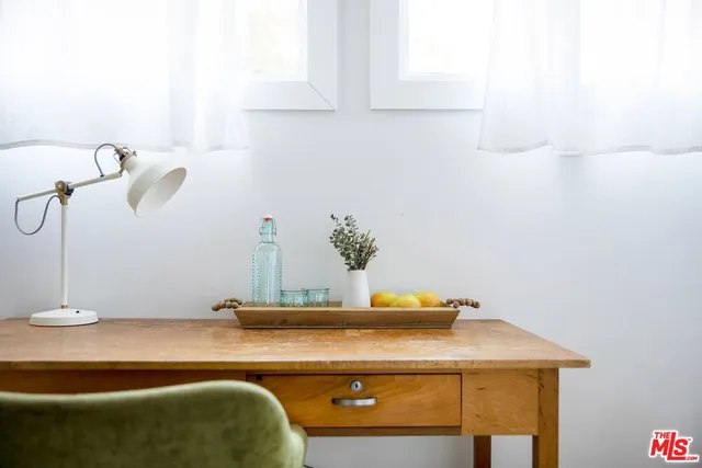 a view of a backyard with plants and lake view