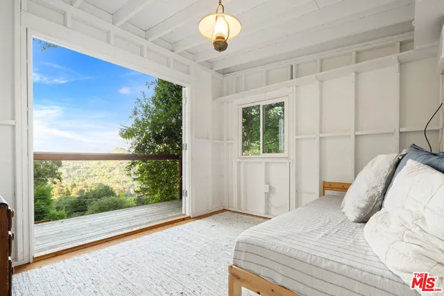 a living room with furniture and a book shelf