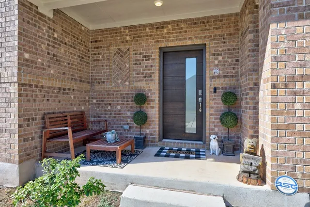a building outdoor space with patio furniture and potted plants