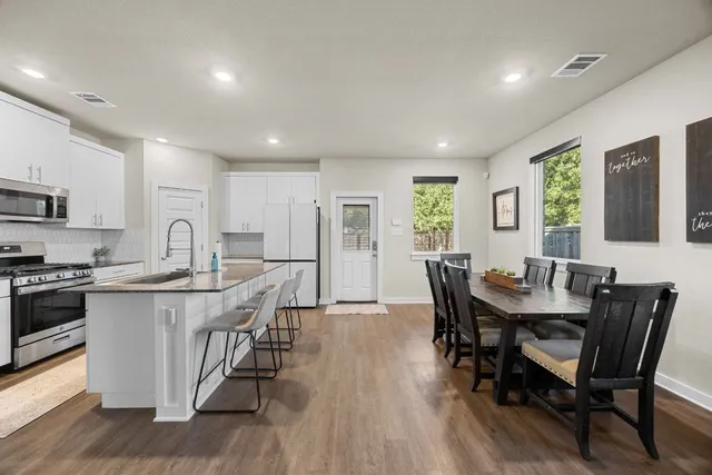 a view of a dining room with furniture window and wooden floor