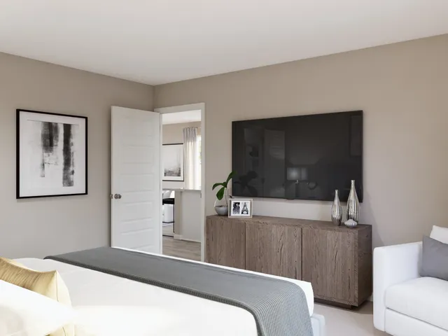 a view of a workspace with furniture and a flat screen tv