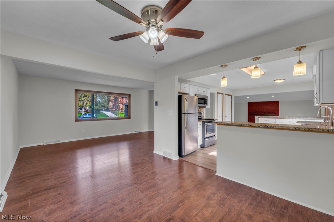 2540 Charney Road University Heights, OH 44118 - Photo 19 of 44 Open-concept living area featuring wood-finish flooring, a ceiling fan, and a large window