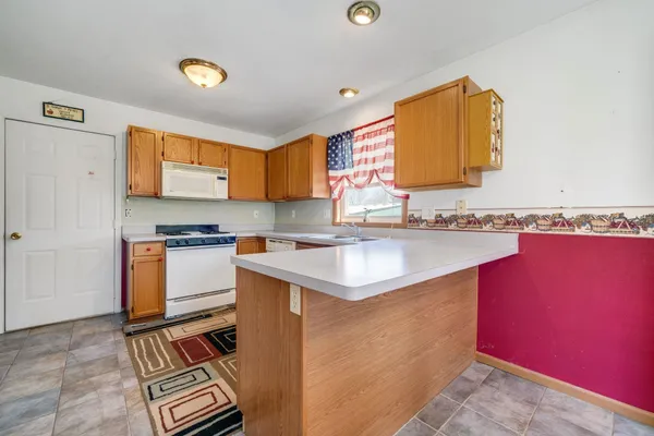 a kitchen with a sink and a stove top oven