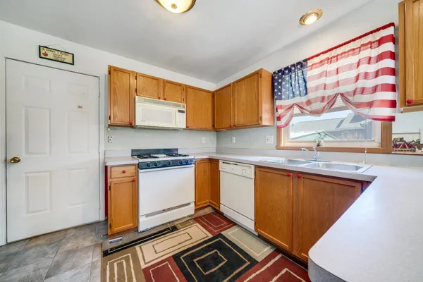 a kitchen with stainless steel appliances granite countertop a stove and a sink