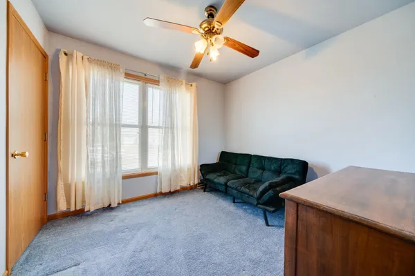 a living room with furniture and a ceiling fan