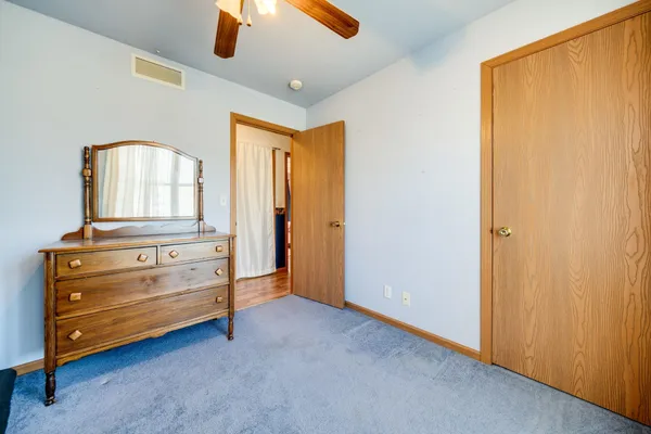 a view of an empty room with a dresser