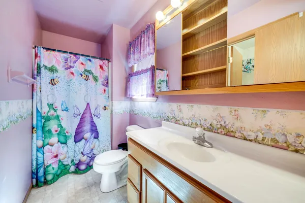 a bathroom with a sink mirror and toilet