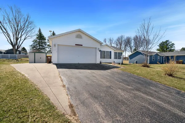 a view of a house with a yard covered in snow