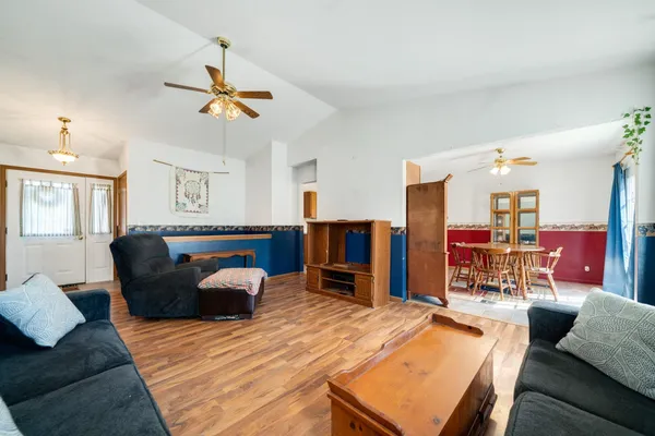 a living room with furniture and kitchen view