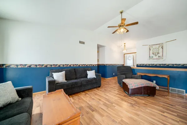 a living room with furniture and a wooden floor