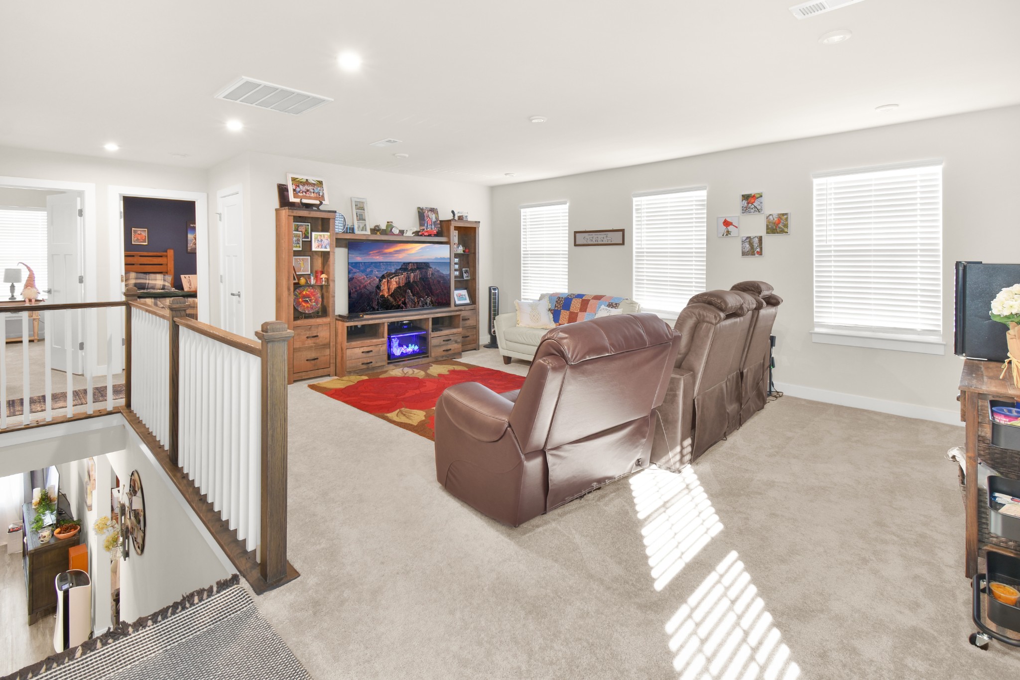 1094 Watermark Way Mount Juliet, TN 37122 - Photo 24 of 29 a living room with furniture a flat screen tv and a floor to ceiling window