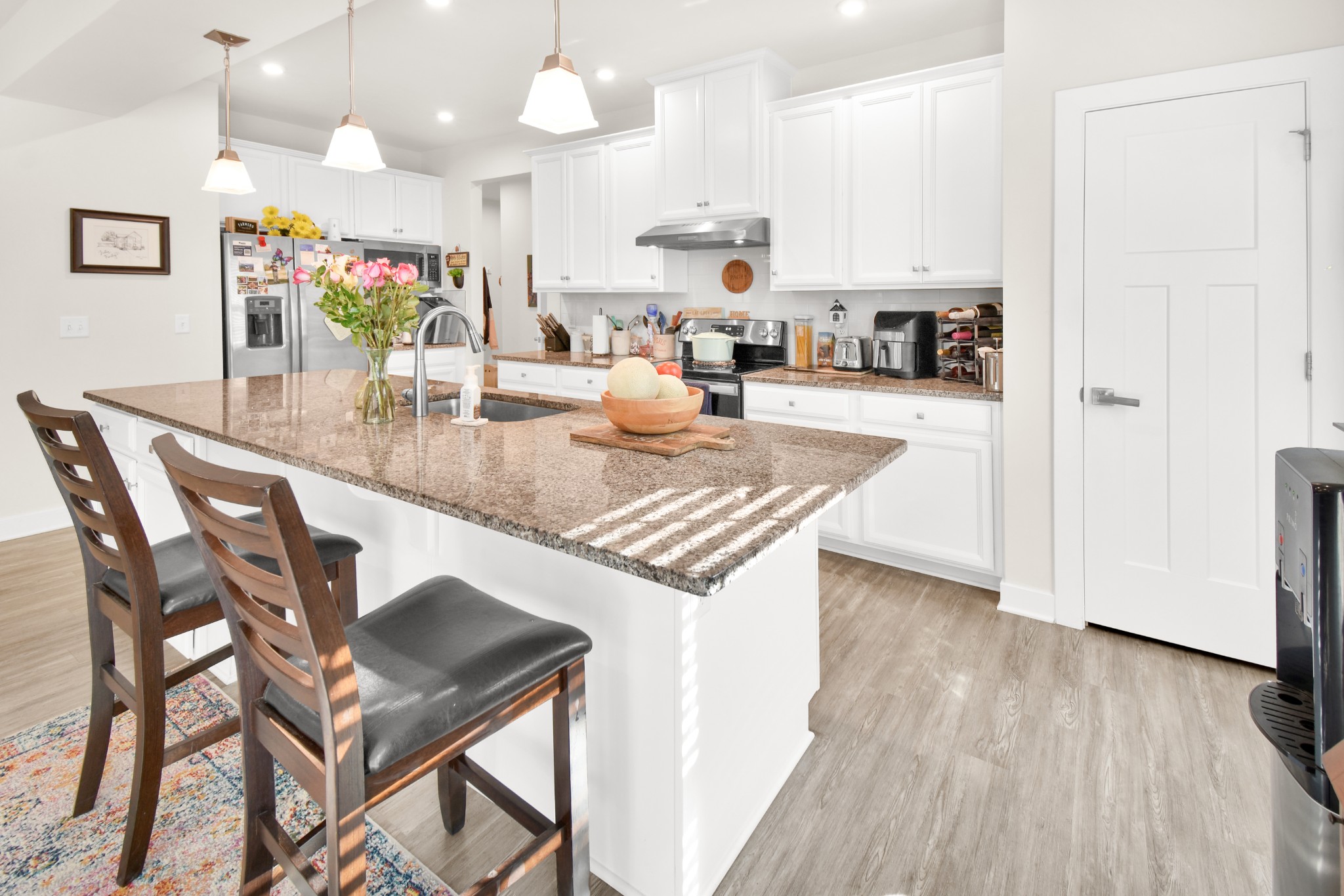 1094 Watermark Way Mount Juliet, TN 37122 - Photo 9 of 29 a kitchen with stainless steel appliances granite countertop a stove top oven a refrigerator a sink and dishwasher with wooden floor