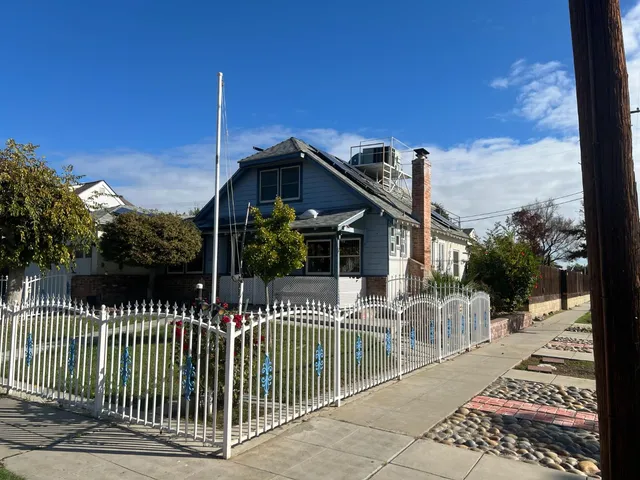 a view of a house with wooden fence