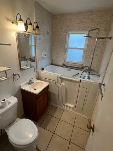 a bathroom with a sink toilet and mirror